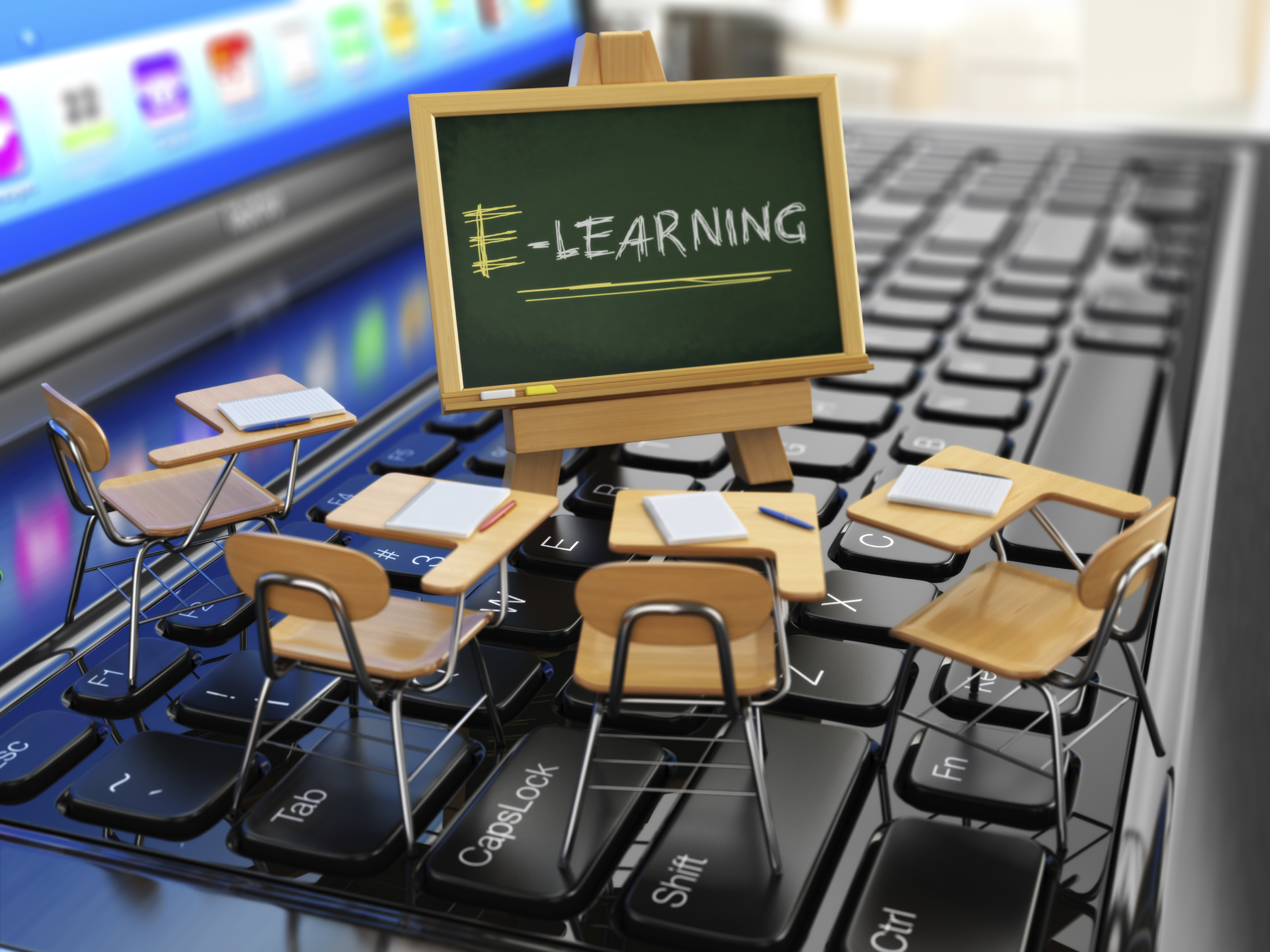 Financial Services training concept image. The words E-learning are shown on a miniature chalkboard standing on a keyboard.