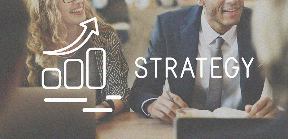 Strategy concept image. The word Strategy appears superimposed over a smiling man and woman in business attire.
