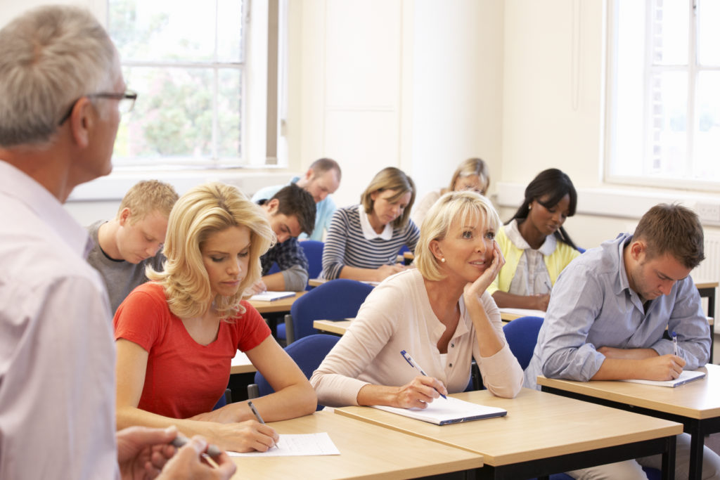 Group of men and women studying in a class