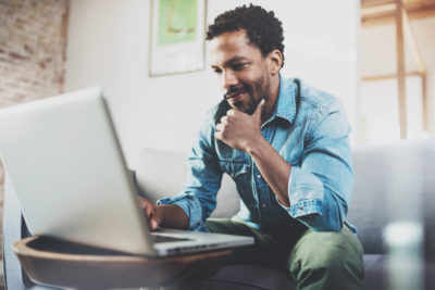 Young man sitting with a laptop