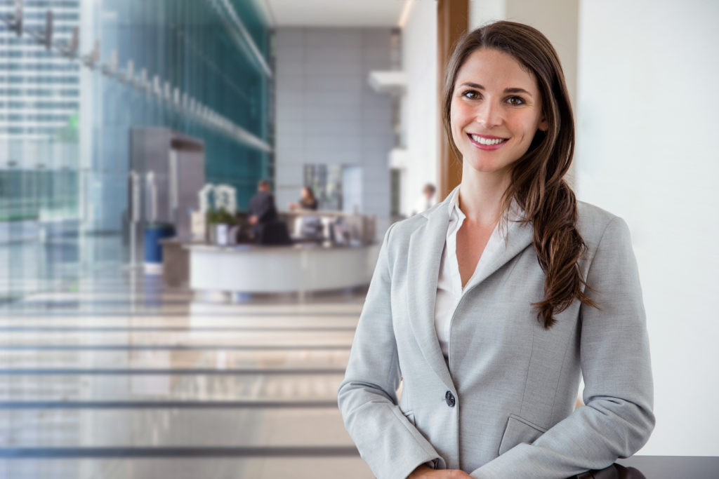 Lady in grey business suit smiles