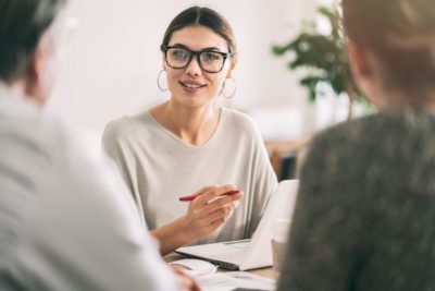 business woman in glasses taking notes