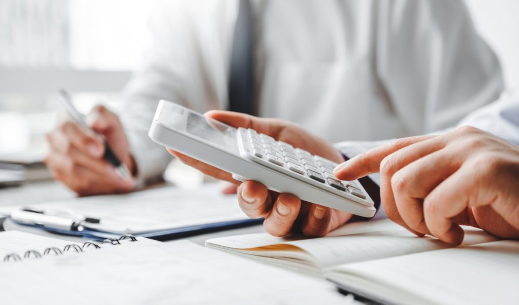 An employer and an apprentice calculating how much tax they will pay.