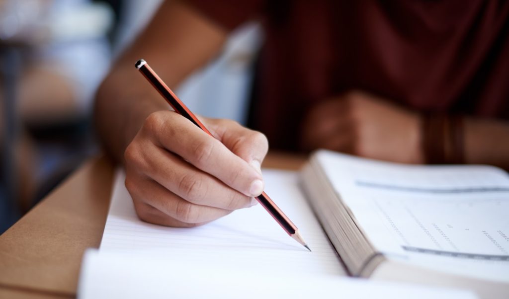 A mortgage advice apprentice taking a CeMAP exam in a test centre