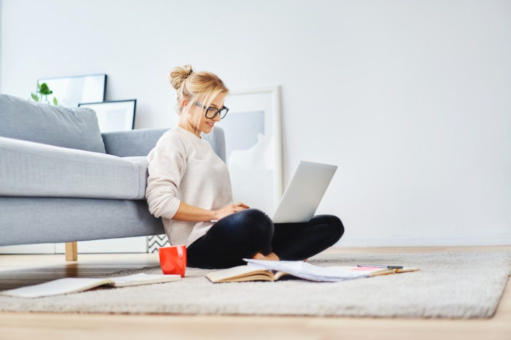 woman sat on floor with a laptop