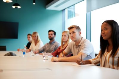 young people attend boardroom meeting
