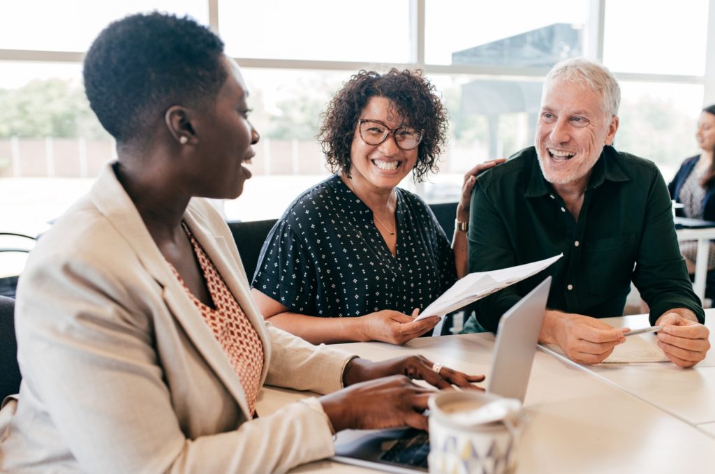 a financial adviser helping two clients with their finances.