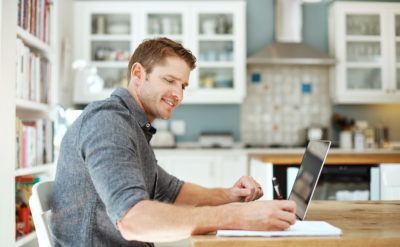 A student studying a financial advice course from home.