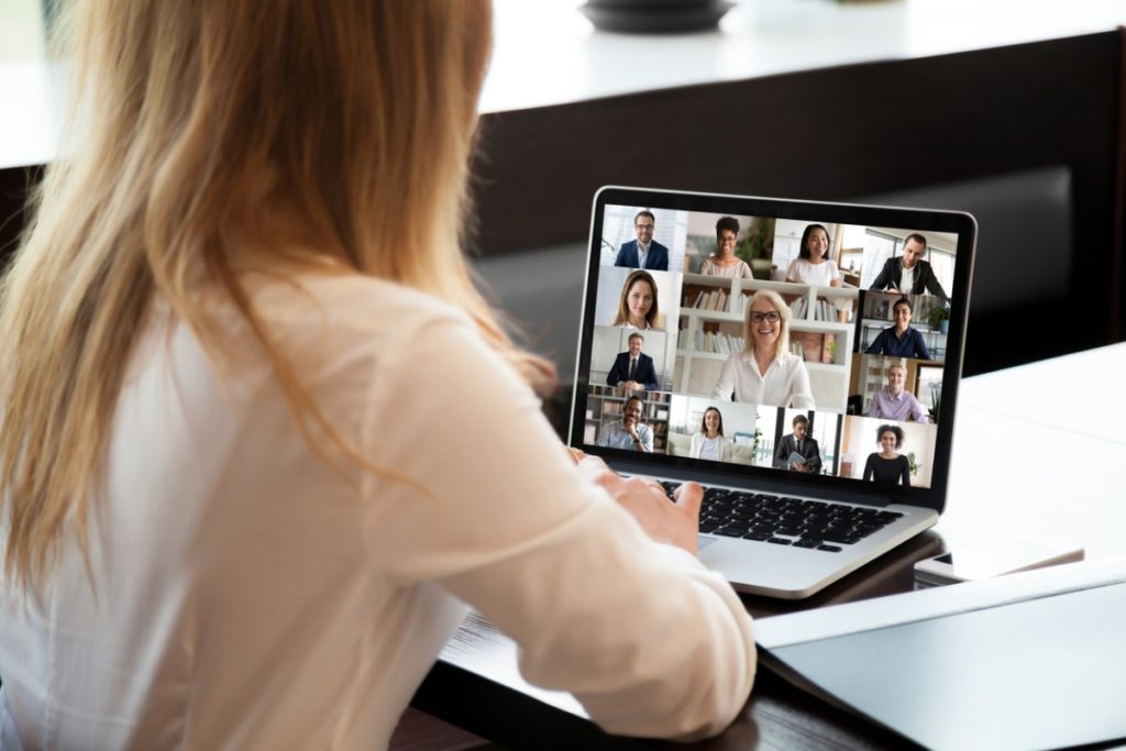 Woman sat at laptop during webinar
