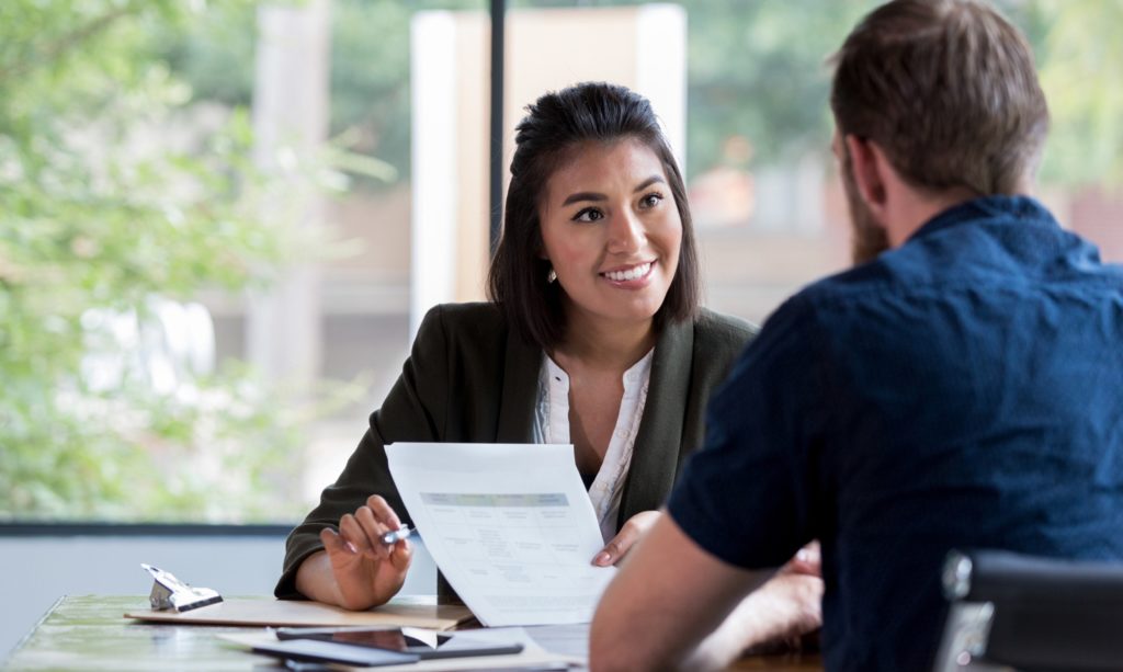 An insurance broker providing a client with expert advice.