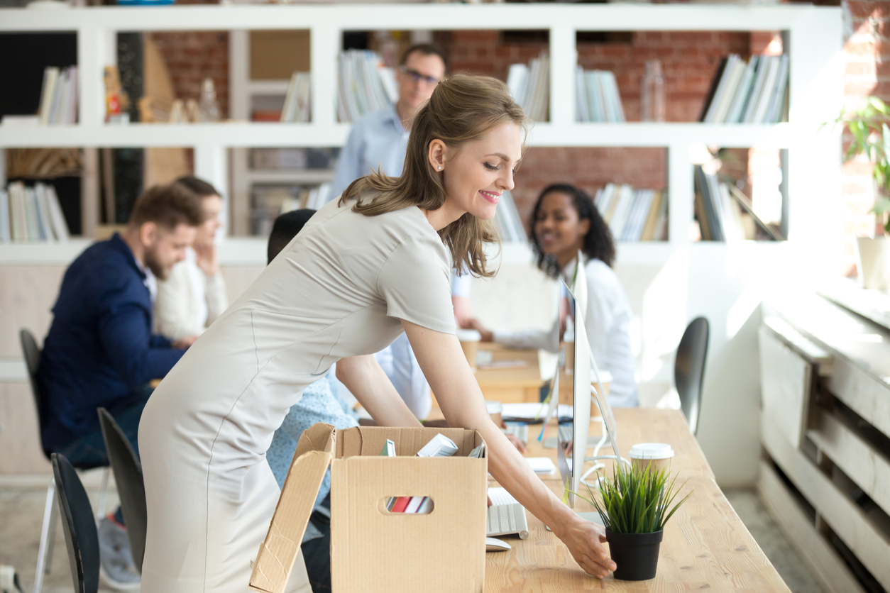 a new employee unpacking a box of personal belongings in the office