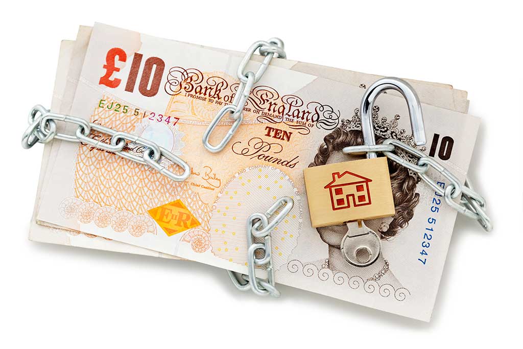 Financial freedom concept. A metal chain is wrapped around a pile of bank notes, the attached padlock has been unlocked.