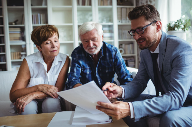 A financial adviser providing advice to a couple.