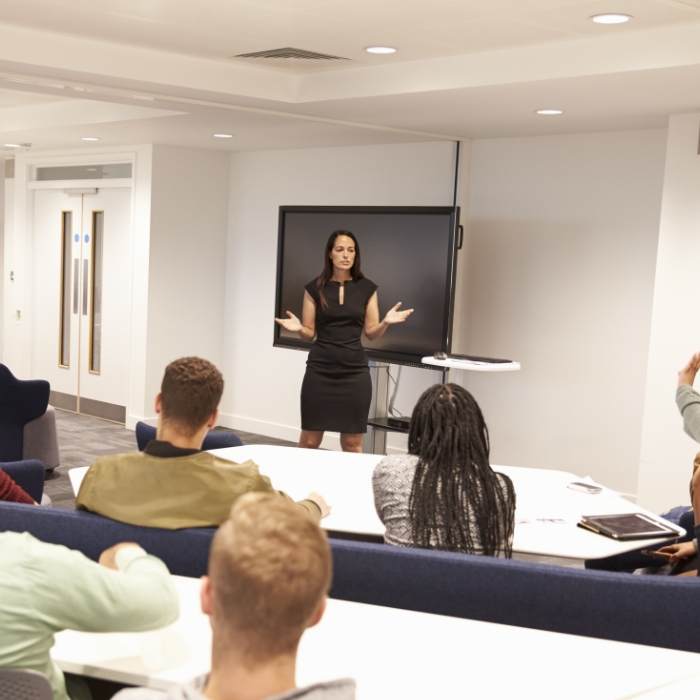 Female instructor teaching a classroom of students