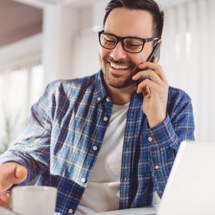 Man smiling while on mobile phone