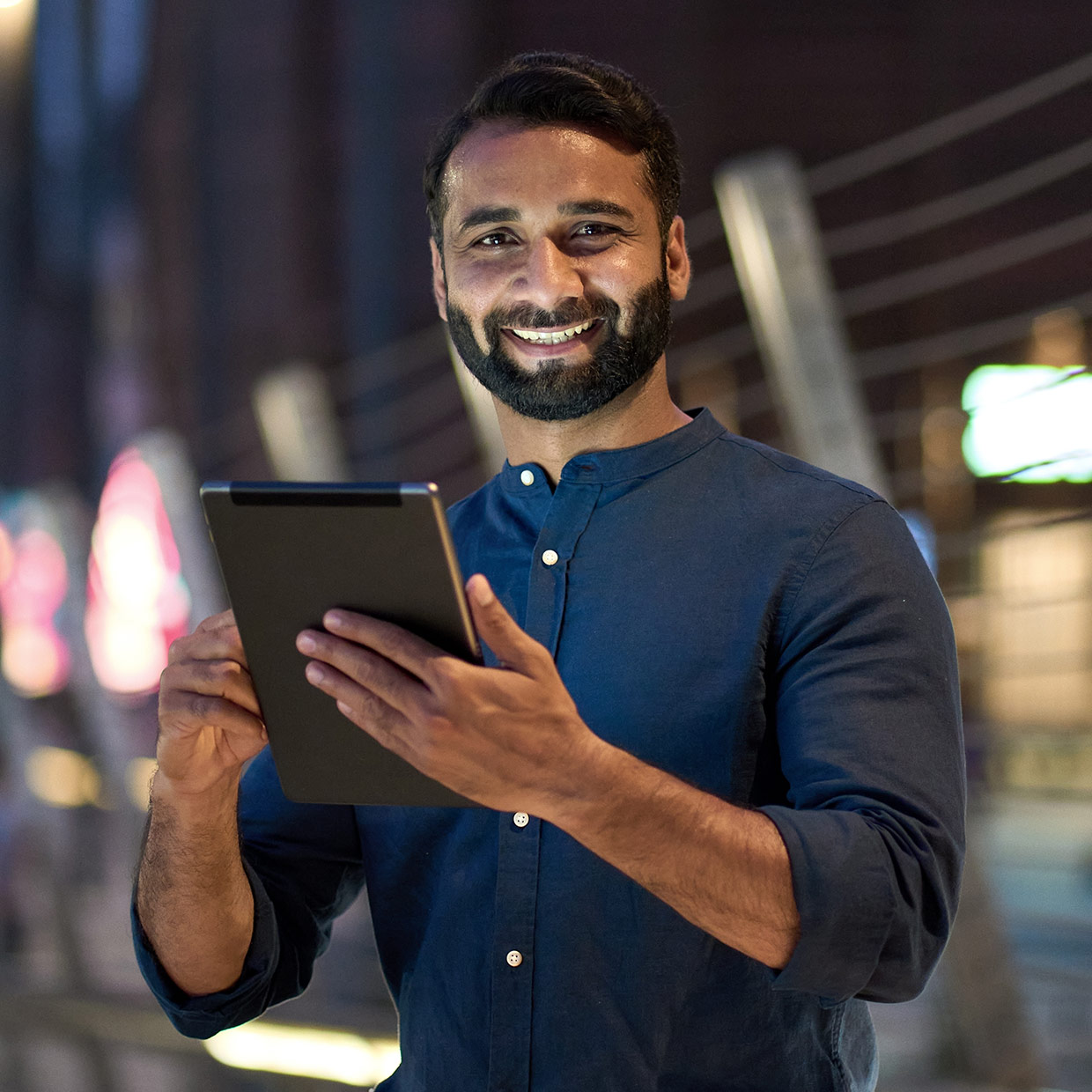 Smiling man holding a tabet device