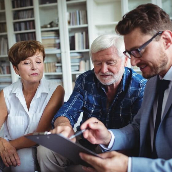 A financial adviser providing advice to a couple.