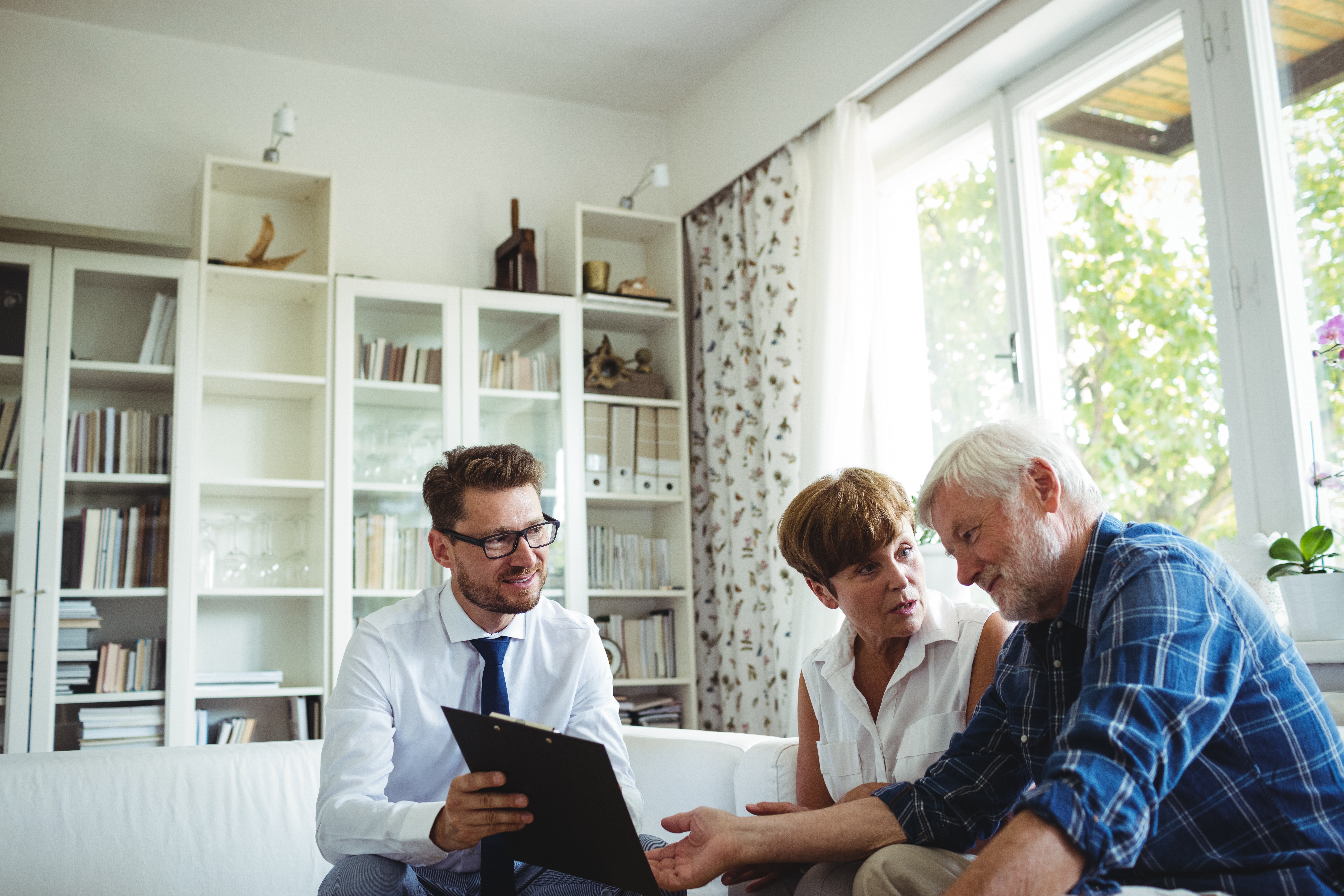A financial adviser helps an older couple to plan their investments.